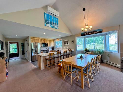a dining room and kitchen with a table and chairs at F4 Warm Fairway Village Townhome mountain views and large lawn So much to do in Carroll