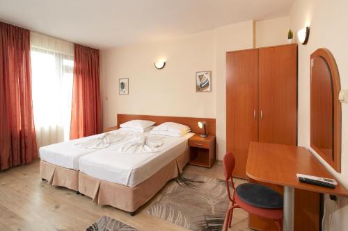 una camera d'albergo con un letto e una scrivania di Nirvana Guest House a Nesebar