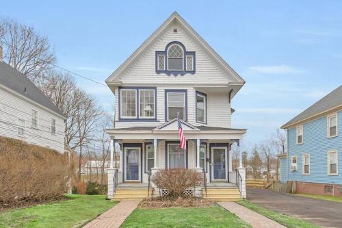 a gray house with a flag in the front yard at Classic West Hartford Center Apartment in West Hartford