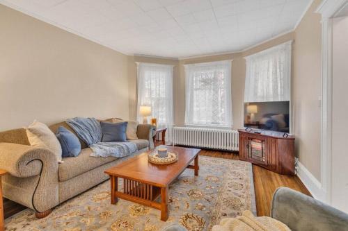 a living room with a couch and a coffee table at Classic West Hartford Center Apartment in West Hartford