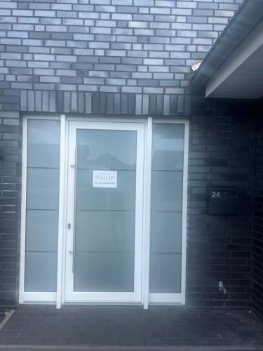 a door to a building with a sign on it at Pension Imhof in Oyten