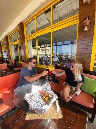a man and woman sitting at a table in a restaurant at Sea Life Apartments-hotel in Hurghada