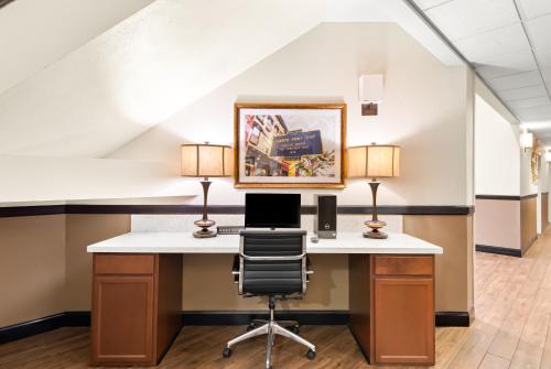 an office with a desk with a computer and two lamps at Best Western Palmyra Inn & Suites in Palmyra