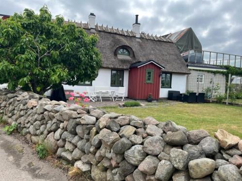 a stone wall in front of a house at Korsvirkeslänga in Helsingborg