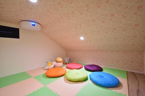 a room with colorful pillows on the floor at HANA HOUSE Tokyo - Family House near Haneda Airport in Tokyo