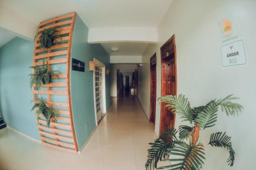 a hallway of a building with plants on the wall at Frota Palace Hotel in Macapá