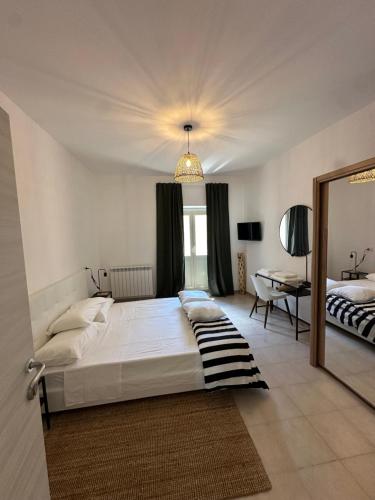 a bedroom with a large bed and a mirror at Clarissa Guest House via di Mezzo 194 in Rieti
