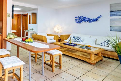 a living room with a couch and a table at Esquinzo Playa 3 Jandia Fuerteventura in Playa Jandia