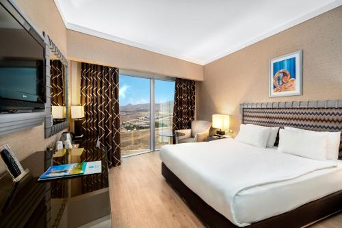 Ένα ή περισσότερα κρεβάτια σε δωμάτιο στο Grand Hotel Konya