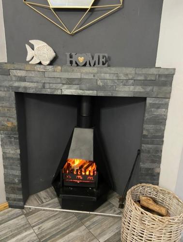 a fireplace with a fire inside of it at ikibiki in Beaufort West
