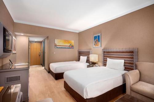 Ένα ή περισσότερα κρεβάτια σε δωμάτιο στο Grand Hotel Konya