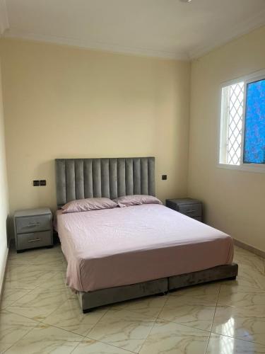 a bedroom with a large bed and two night stands at 3 Chaaban 1, 1136 in Larache
