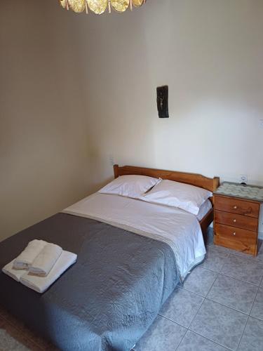 a bedroom with a bed and a night stand at Dimitris House in Pramanta