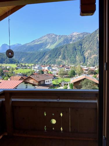 a window with a view of a town and mountains at Ferienwohnung Anita in Umhausen