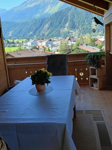 a blue table with a potted plant on a balcony at Ferienwohnung Anita in Umhausen