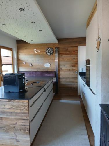 a kitchen with wooden walls and a counter top at Ferienwohnung Anita in Umhausen