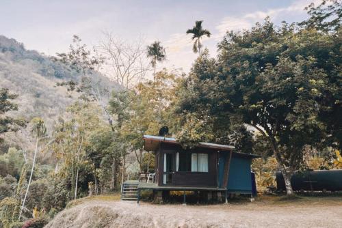 a small house sitting on top of a hill at Chiewlan Camp and Resort in Ban Pha Saeng Lang