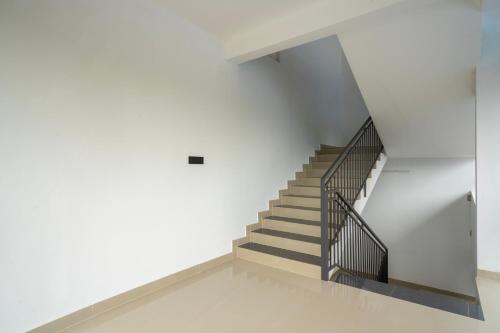a staircase in a white building with a stair case at Amala Arcade AC Rooms in Trichūr