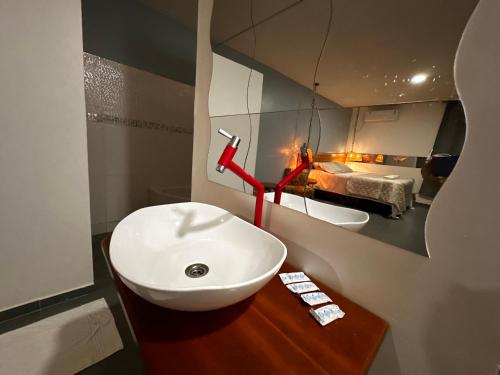 a bathroom with a white sink and a mirror at Hotel La Villa Morena in Oiapoque