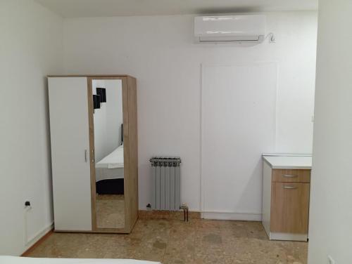 a mirror in a room with a white wall at Apartman Mara in Neum