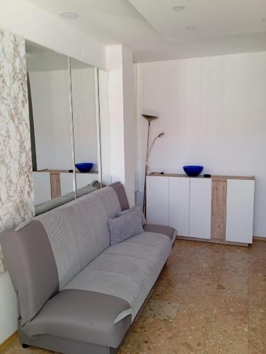 a living room with a gray couch in a room at Apartman Mara in Neum