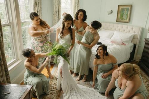 a group of women standing around a bride at Harvard House-The Gathering Place in Waltham