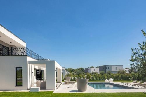 a villa with a swimming pool and a house at Villa BB Rapsody 10 with heated salt water pool in Butkovići