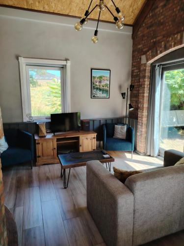 a living room with a couch and a table at La Sérénade in La-Roche-en-Ardenne