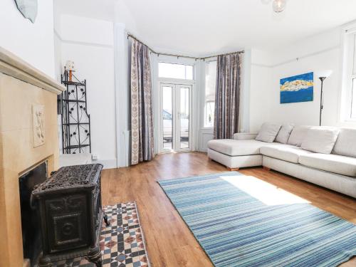 a living room with a couch and a fireplace at Goldhurst Apartment in Hastings