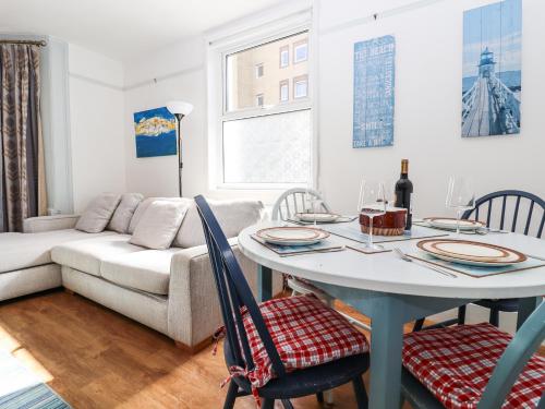 a living room with a table and a couch at Goldhurst Apartment in Hastings