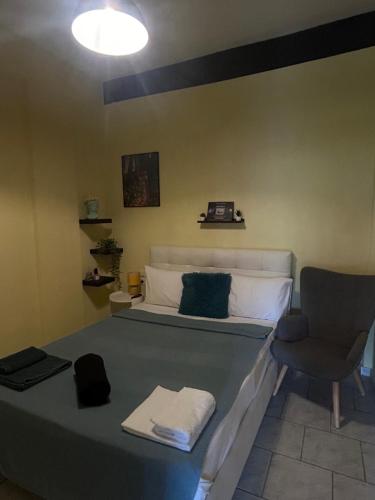 a bedroom with a bed with a chair and a chair at Catch n relax in Kalabaka