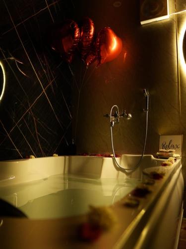 a bathroom with a bath tub with a heart balloon at Dyson Ville in Dehradun
