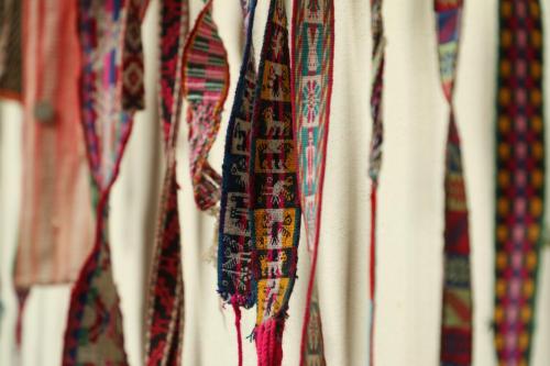 a bunch of ties hanging on a rack at Hostel Cultural Pata y Perro in Tarija