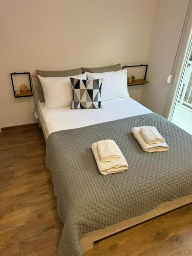 a bedroom with a large bed with two towels on it at Lyda Apartment in Alexandroupoli