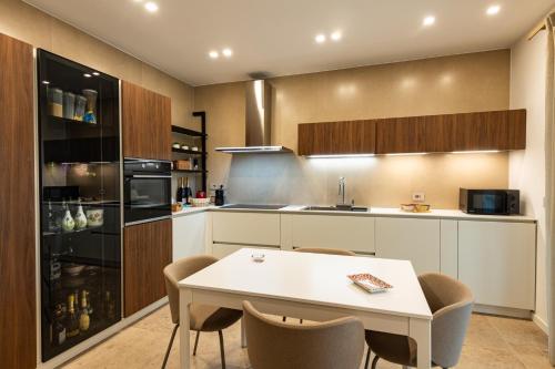 a kitchen with a white table and chairs at VENTO DI GISIRA in Brucoli