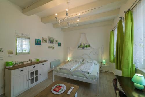 a bedroom with a bed and a sink and a table at Penzion U Zámku in Mělník