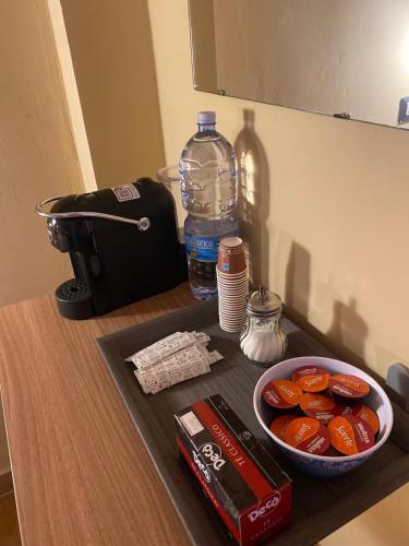 a counter with a bowl of food and a bottle of water at Musetta sicilian hospitality in Milazzo