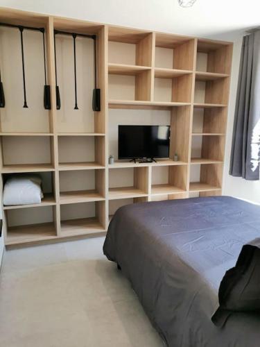 une chambre avec un lit et une télévision à écran plat dans l'établissement Appartement centre ville rdc, à Évreux