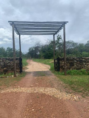 a dirt road with a structure on the side of a road at ECOS GAIA Casa Céu in Cavalcante