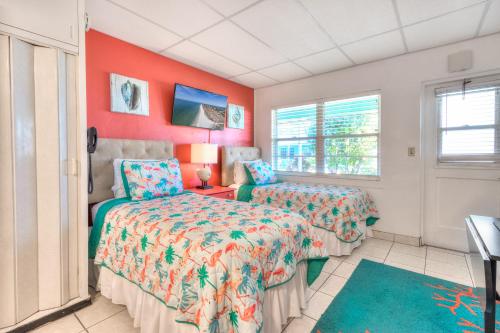 a bedroom with two beds and a window at Tropic Terrace Suite #24 - Beachfront Resort in St Pete Beach