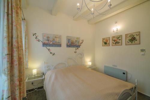 a hospital room with a bed and a chandelier at Penzion U Zámku in Mělník
