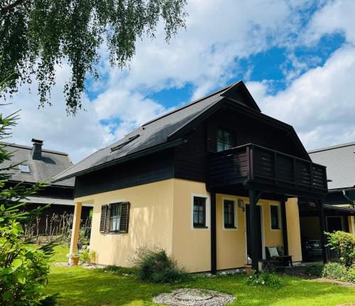 a house with a black roof at Ferienhaus im Rosental Kärnten in Feistritz im Rosental