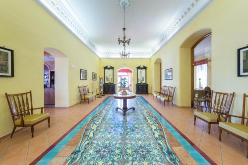 a hallway with a table and chairs in a building at Hotel Iaccarino in SantʼAgata sui Due Golfi