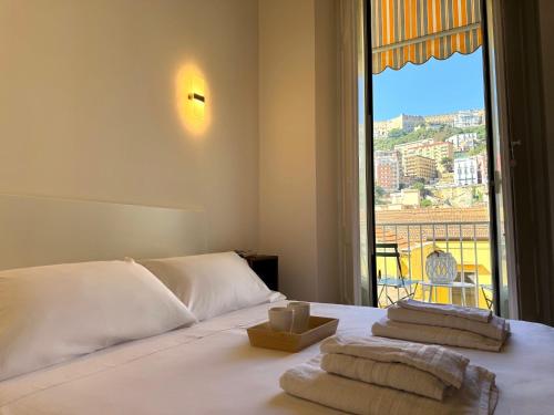 a bedroom with a bed with a view of a balcony at Montesanto Charm Centro Storico in Naples