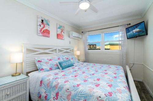 a bedroom with a bed and a window at Tropic Terrace Suite #44 - Beachfront Resort in St Pete Beach