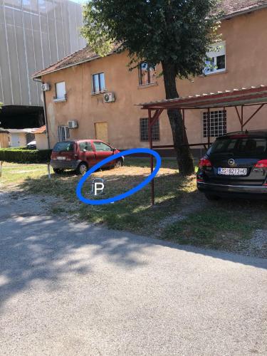 a blue circle on a sign in front of a car at Studio Stipe- with free parking, self check-in 0-24 in Zagreb
