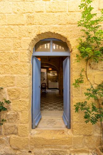 an entrance to a building with a blue door at Historic Hideaways - 900 Year Old Converted Studios in Victoria