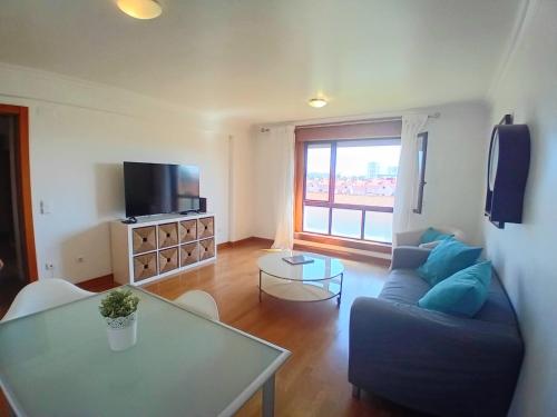 a living room with a couch and a table at Lisbon Blue - Metro at your Door in Lisbon