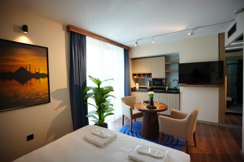 a room with two beds and a table and a kitchen at Dream house 22 in Istanbul