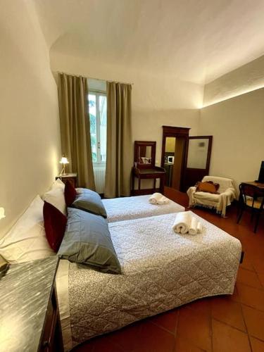 a bedroom with two beds with a dog laying on them at Appartamento Bilocale in Riolo Terme